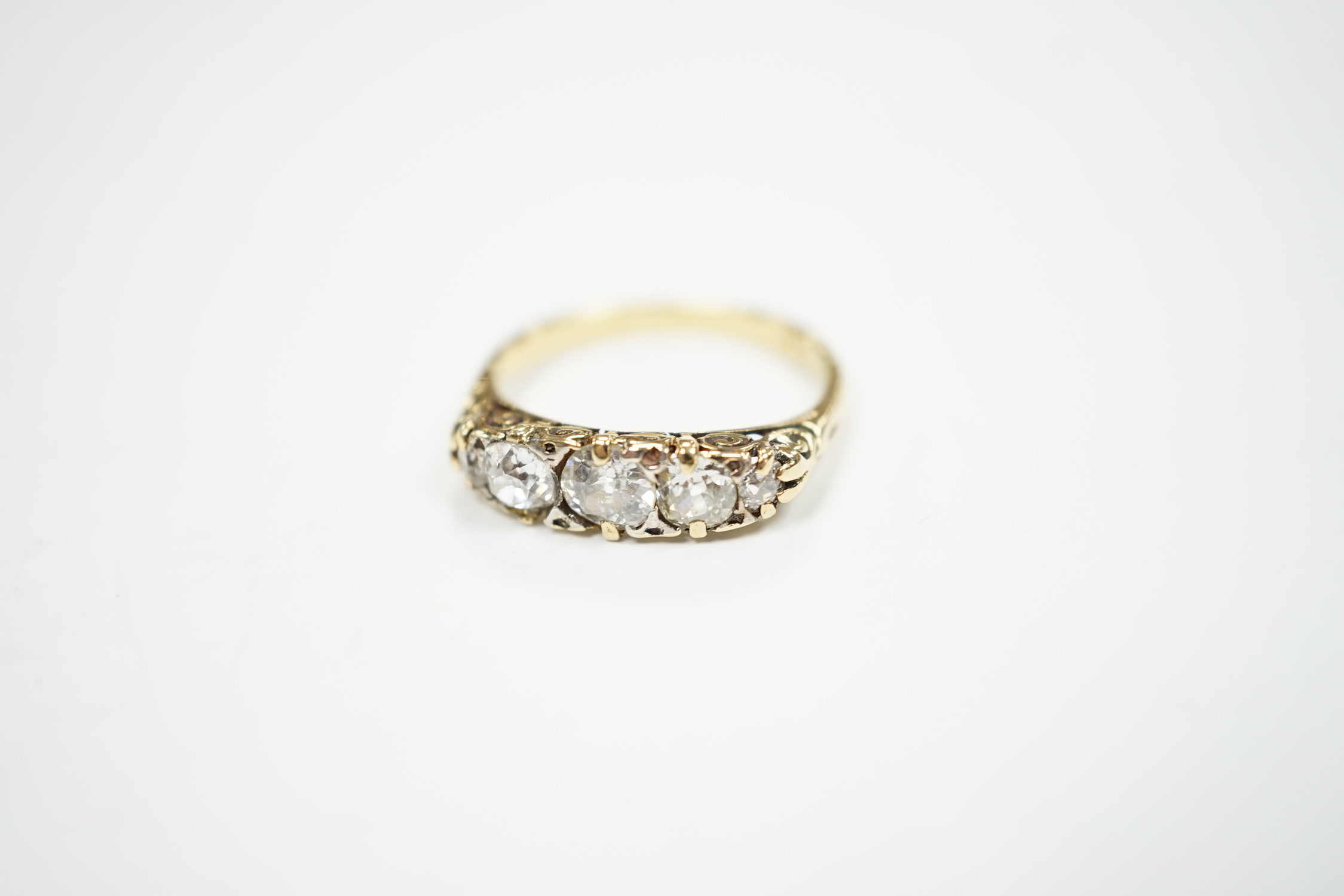 An 18ct and graduated five stone diamond set half hoop ring, size L, gross weight 2.8 grams (splits to setting).